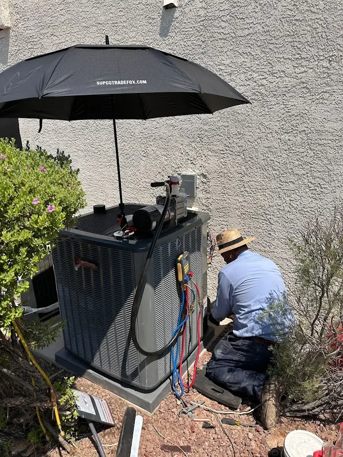 HVAC technician performing outdoor AC maintenance in Waynesville